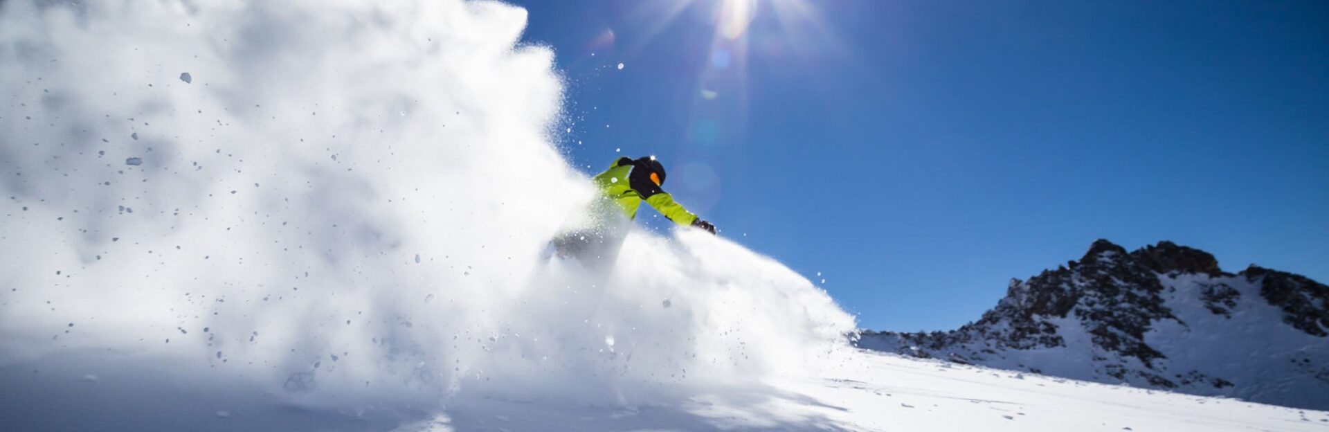 Skier in High Mountains During Sunny Day